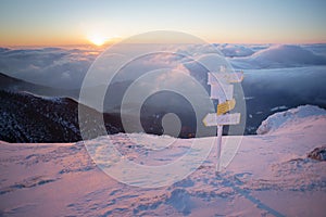 Sunrise in mountains, orientation signs in foreground