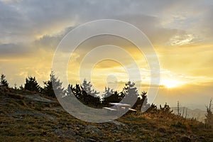 The Sunrise in the mountains and wooden table