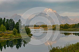 Sunrise on Mt. Moran reflecting in the Snake River in Teton National Park in the fall.