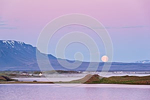 Sunrise in Myvatn lake with fog and moon, Iceland