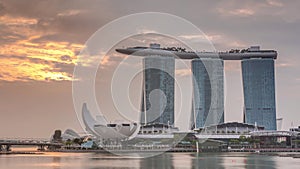 Sunrise near Marina Bay Sands Hotel dominates the skyline at Marina Bay in Singapore timelapse.