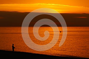 Sunrise with orange tones in the sea.