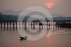 Sunrise over Ancient mon wooden bridge in songgaria river Sangkhla Buri District kanchanaburi thailand