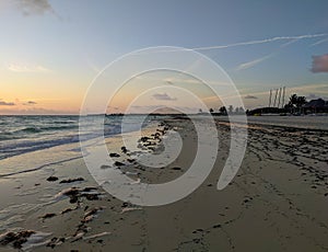 Sunrise over the atlantic ocean. View of the sandy beach and tall palms. Cayo Coco, Cuba photo