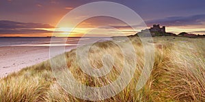 Sunrise over Bamburgh Castle, Northumberland, England photo