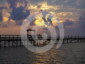 A Sunrise over the Bay with pier destruction in Rockport Texas a