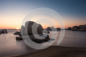 Sunrise over boulders at Cavallo Island in Corsica