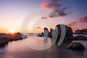 Sunrise over boulders at Cavallo Island in Corsica