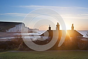 Sunrise over coastguard cottages at Seaford Head with Seven Sisters in background