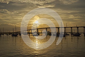 Sunrise over Coronado Bay, San Diego, California, with boats anchored near Coronado Bridge