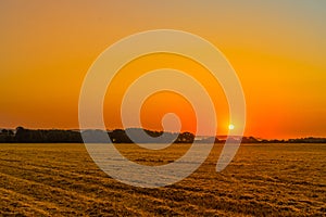 Sunrise over a countryside field