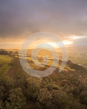 Sunrise over Denbighshire hills, Wales, as the sun breaks clouds. photo