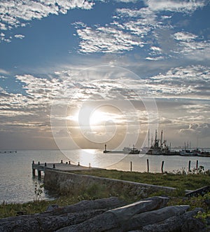 Sunrise over Dock Pier Seawall Jetty of Puerto Sunrise over Juarez in Cancun Bay Mexico