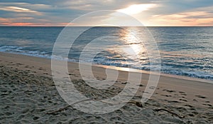 Sunrise over driftwood on beach in San Jose Del Cabo in Baja California Mexico photo