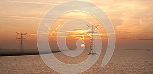 Sunrise over the Dutch sea with two electricity photo