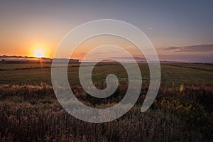 Sunrise over a farm field in early fall