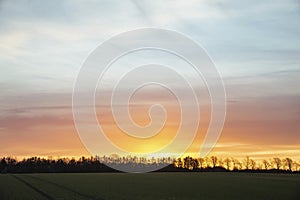 Sunrise over a field in Denmark. Rural landscape