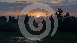 Sunrise over a field in fog