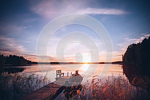 Sunrise over the fishing pier at the lake in Finland