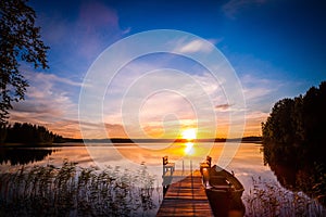 Sunrise over the fishing pier at the lake in Finland