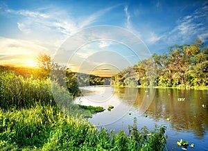 Sunrise over the forest river