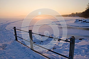 Sunrise over frozen lake