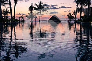 Sunrise over the Gulf of Mexico reflected into the infinity pool at the resort