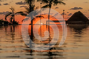 Sunrise over the Gulf of Mexico reflected into the infinity pool at the resort