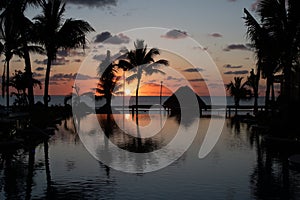 Sunrise over the Gulf of Mexico reflected into the infinity pool at the resort