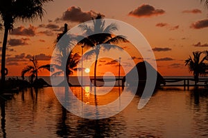 Sunrise over the Gulf of Mexico reflected into the infinity pool at the resort