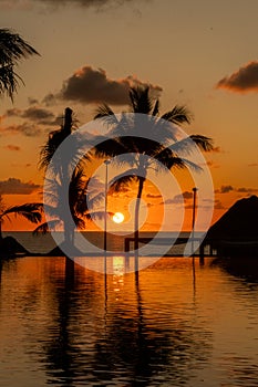 Sunrise over the Gulf of Mexico reflected into the infinity pool at the resort