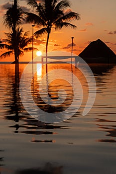 Sunrise over the Gulf of Mexico reflected into the infinity pool at the resort