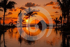 Sunrise over the Gulf of Mexico reflected into the infinity pool at the resort