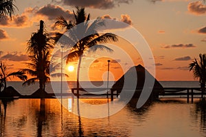 Sunrise over the Gulf of Mexico reflected into the infinity pool at the resort