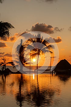 Sunrise over the Gulf of Mexico reflected into the infinity pool at the resort