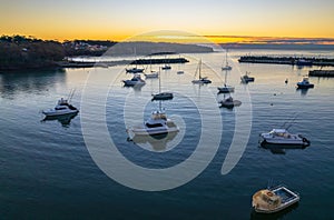 Sunrise over the harbour with low cloud bank and boats