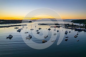 Sunrise over the harbour with low cloud bank and boats