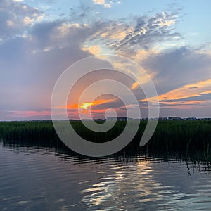 Sunrise over the inlet on a cloudy day creating awesome colors in the clouds