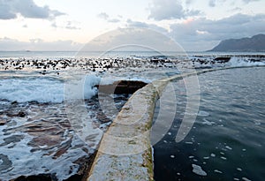 Sunrise over jetty at Dale Brook Tidal Swim Pool in Cape Town South Africa SA