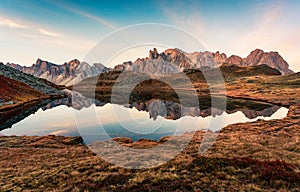 Sunrise over Lac Long with Massif des cerces reflection on the lake in Claree valley at French Alps, France