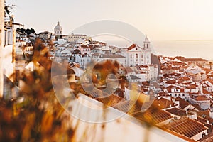 Sunrise Over Lisbon Old Town Alfama - Portugal. Lisbon Golden Hour Skyline. Balcony View on Alfama Old Town of Lisbon and Tagus photo