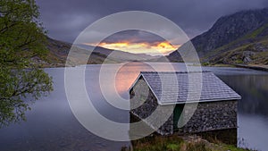 Sunrise over Llyn Ogwne and boathouse, Snowdonia National Park, Wales, UK