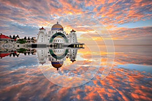 Sunrise over malacca straits mosque