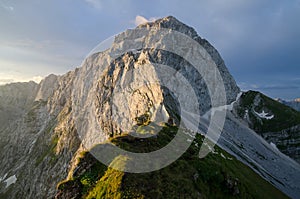 Sunrise over Mangart with sheeps at the foot of the mountain, Julian Alps, Mangart Pass, Slovenia, Triglav national park, Europe