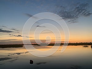 Sunrise over the marsh in murrells inlet with crab trap bouy