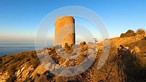 Sunrise over Mediterranean sea. Historic Torre Vigia De Cerro Gordo