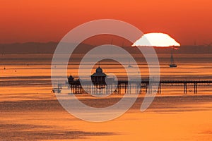 Sunrise over the Menai Strait showing Bangor Pier and the mountains of Snowdonia