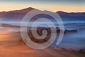 Sunrise Over Misty Landscape. Scenic View Of Foggy Morning Sky With Rising Sun Above Misty Forest.