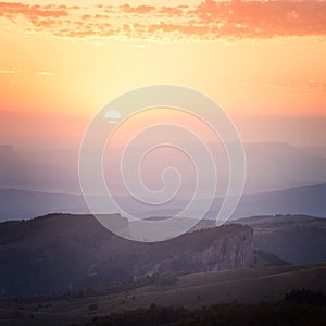 Sunrise over the mountains and the forest at dawn