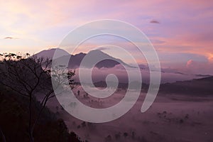 Sunrise over the mountains. A misty morning view on the mountain at sunrise. Kintamani, Bali, Indonesia